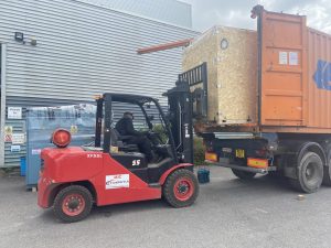 Sea container with Crocodile crate being loaded by forklift