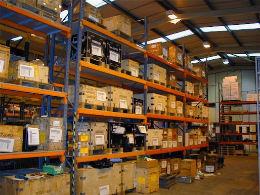 Row of warehouse shelving full of wooden shipping crates supplied by Crocodile